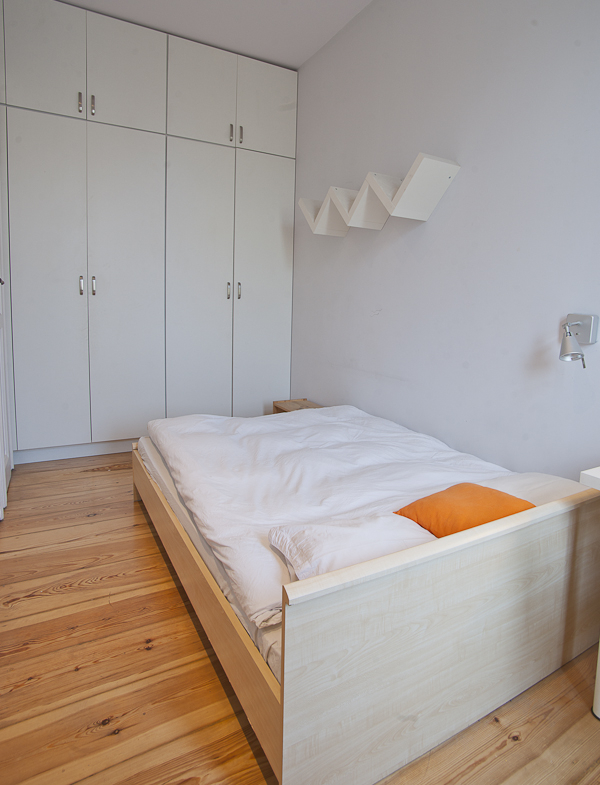 bed with wall shelf