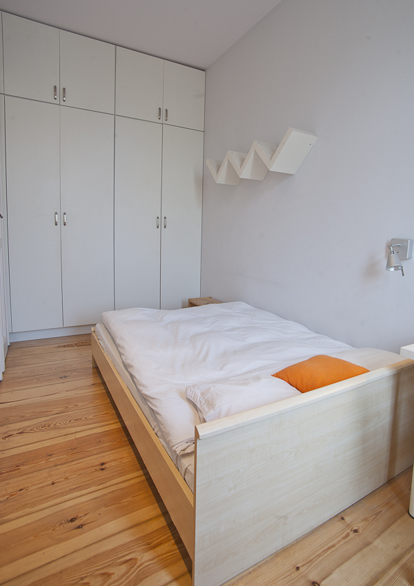 bed with wall shelf